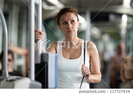 Portrait of an attractive middle-aged woman on bus or tram Portrait of an attractive middle-aged woman on bus or tram 117727639