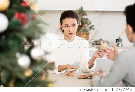 Son takes pocket money from mom before celebrating Christmas in room 117727748