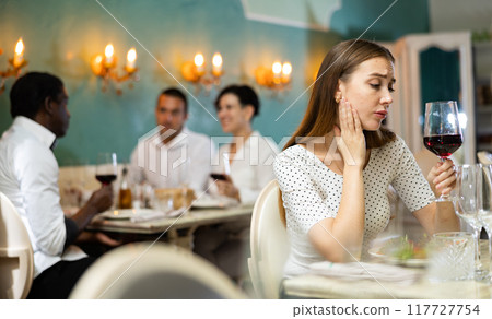 Lonely woman in the restaurant 117727754