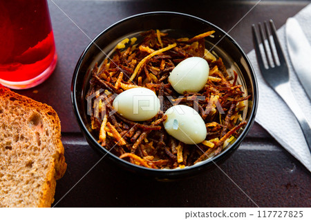 Russian salad Capercaillies Nest - boiled eggs and fried potatoes closeup Russian salad Capercaillies Nest - boiled eggs and fried potatoes closeup 117727825