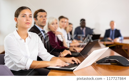 Portrait of business woman using laptop at business meeting Portrait of business woman using laptop at business meeting 117727864