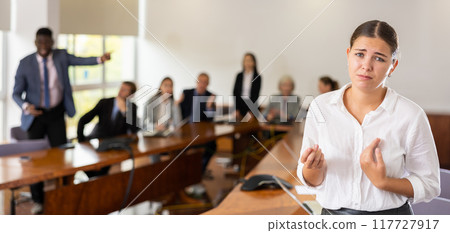Devastated millennial white brunette female worker being fired Devastated millennial white brunette female worker being fired 117727917