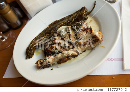 Iberian pork in roquefort sauce with baked pepper Iberian pork in roquefort sauce with baked pepper 117727942