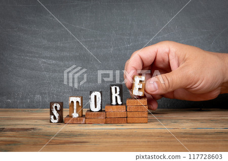 STORE. Wooden letters, alphabet blocks on steps. development and growth concept 117728603