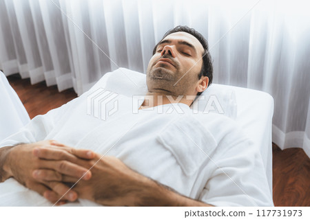 Caucasian man customer enjoying relaxing anti-stress massage. Quiescent Caucasian man customer enjoying relaxing anti-stress massage. Quiescent 117731973