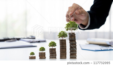 Growth coin stack with tree on top symbolize green business investment. Shrewd 117732095