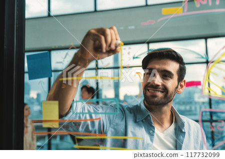 Portrait of handsome businessman writing marketing idea on glass wall. Tracery. Portrait of handsome businessman writing marketing idea on glass wall. Tracery. 117732099