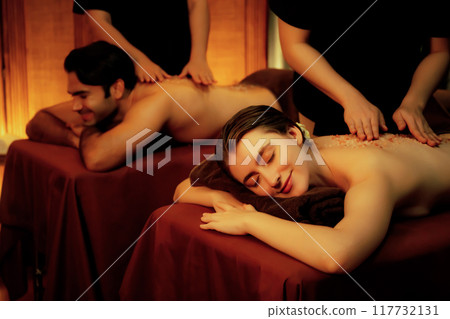Couple customer having exfoliation treatment in luxury spa. Quiescent Couple customer having exfoliation treatment in luxury spa. Quiescent 117732131