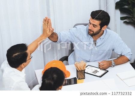 Diverse group of civil engineer and client celebrate and high five. Prudent 117732332