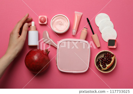 Cosmetics with pomegranate on a pink background. Cosmetics with pomegranate on a pink background. 117733025