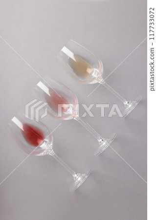 Glasses with different types of wine, on a gray background. Glasses with different types of wine, on a gray background. 117733072