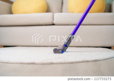 Woman cleaning Carpet with cordless Vacuum cleaner. Housewife using wireless Vacuum for big cleaning home. Housework, Housecleaning, Housekeeping, Removes dust, Domestic hygiene and daily routine Woman cleaning Carpet with cordless Vacuum cleaner. Housewife using wireless Vacuum for big cleaning home. Housework, Housecleaning, Housekeeping, Removes dust, Domestic hygiene and daily routine 117733273