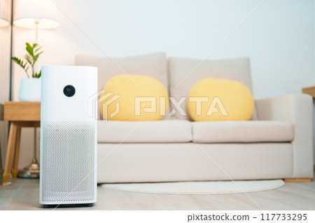Air Purifier in cozy living room. Purification system for filter and cleaning or removing dust PM2.5 HEPA and virus in home. Allergy, Pure air, health lifestyle, Wellness life and Air Pollution 117733295
