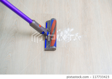 Woman cleaning floor with cordless Vacuum cleaner. Housewife using wireless Vacuum for big cleaning home. Housework, Housecleaning, Housekeeping, Removes dust, Domestic hygiene and daily routine Woman cleaning floor with cordless Vacuum cleaner. Housewife using wireless Vacuum for big cleaning home. Housework, Housecleaning, Housekeeping, Removes dust, Domestic hygiene and daily routine 117733423