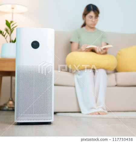 Air Purifier with woman read and relax on sofa. Purification system for filter and cleaning dust PM2.5 HEPA and virus in home. Allergy, Pure air, health lifestyle, Wellness life and Air Pollution Air Purifier with woman read and relax on sofa. Purification system for filter and cleaning dust PM2.5 HEPA and virus in home. Allergy, Pure air, health lifestyle, Wellness life and Air Pollution 117733438