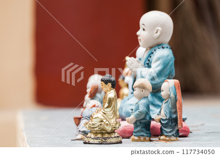 Little Buddha miniature statues, close up photo with soft focus Little Buddha miniature statues, close up photo with soft focus 117734050
