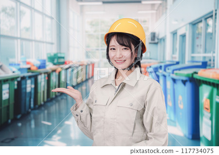 A young woman working in garbage collection A young woman working in garbage collection 117734075
