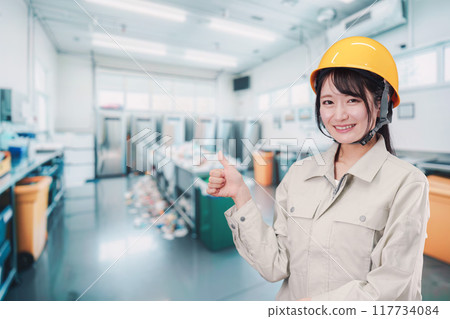 A young woman working in garbage collection A young woman working in garbage collection 117734084