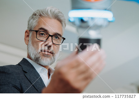 Automation, robotics engineer working on robotic knee replacement surgery project. Concept of modern technology in medicine, automated processes, healthcare. 117735827