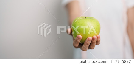 woman hand hold green Apple, happy female fitness choose fruit is Healthy food. Dieting control, Weight loss, Obesity, eating lifestyle and nutrition concepts woman hand hold green Apple, happy female fitness choose fruit is Healthy food. Dieting control, Weight loss, Obesity, eating lifestyle and nutrition concepts 117735857