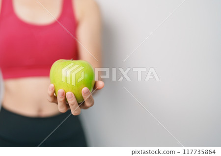 woman hand hold green Apple, happy female fitness choose fruit is Healthy food. Dieting control, Weight loss, Obesity, eating lifestyle and nutrition concepts woman hand hold green Apple, happy female fitness choose fruit is Healthy food. Dieting control, Weight loss, Obesity, eating lifestyle and nutrition concepts 117735864