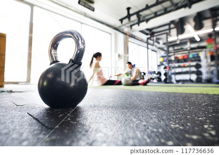 Kettlebells on floor in gym. Gym equipment for strength training. Kettlebells on floor in gym. Gym equipment for strength training. 117736636
