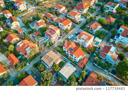 Aerial view of houses with red roofs in suburban neighborhood Aerial view of houses with red roofs in suburban neighborhood 117738483
