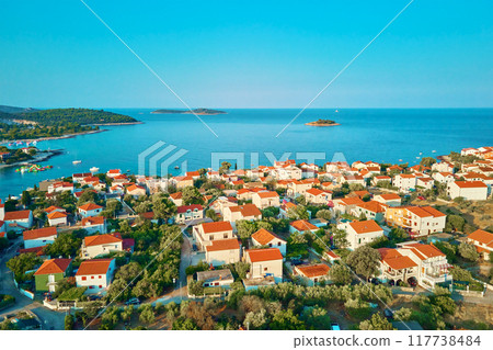 Aerial view of residential buildings of coastal town near sea beach 117738484