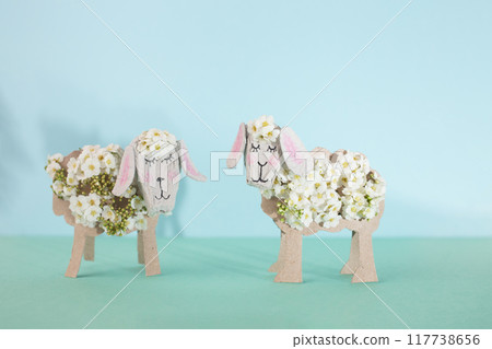 Get crafty this Easter with DIY papercraft decorations. Utilize recycled materials like toilet roll tubes to create charming sheep table decor 117738656