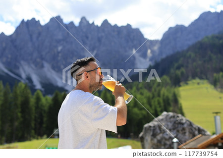 Savoring a Delightfully Refreshing Beverage While Surrounded by a Stunning Mountain View Savoring a Delightfully Refreshing Beverage While Surrounded by a Stunning Mountain View 117739754