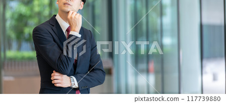 Businessman thinking at hand Businessman thinking at hand 117739880