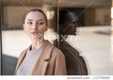 Young beautiful woman wearing coat walking in the city centre of Prague, Europe Young beautiful woman wearing coat walking in the city centre of Prague, Europe 117739905