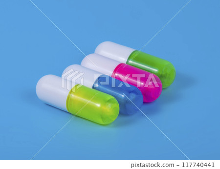 Different pills on blue background Different pills on blue background 117740441