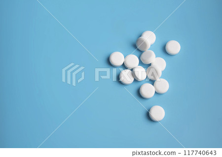 whte pills or tablets for virus on blue background whte pills or tablets for virus on blue background 117740643