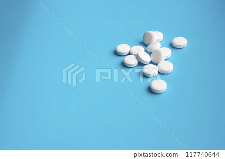 whte pills or tablets for virus on blue background whte pills or tablets for virus on blue background 117740644