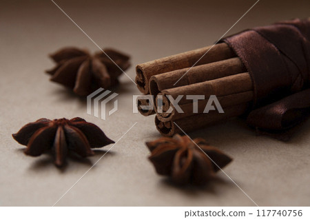 Cinnamon stick with star anis on the craft background Cinnamon stick with star anis on the craft background 117740756