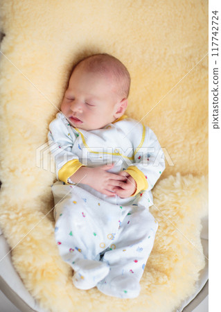 Little baby on white bed 117742724