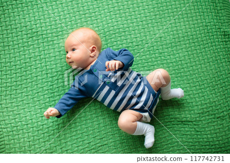 Little baby on colorful knitted blanket 117742731