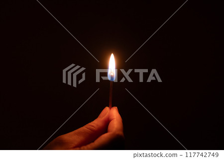 Light a match in a dark room 117742749