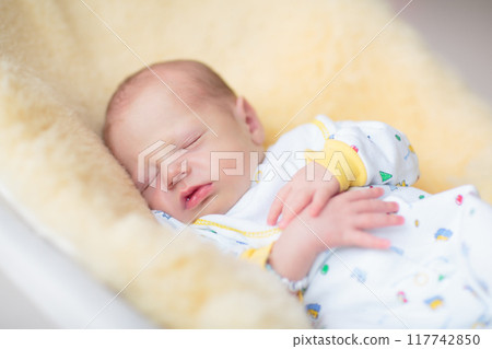 Little baby on white bed 117742850