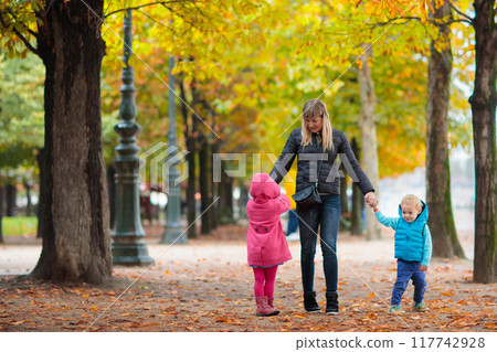 Mother and baby in autumn. Fall outdoor family fun. Mother and baby in autumn. Fall outdoor family fun. 117742928