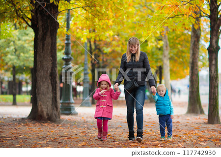 Mother and baby in autumn. Fall outdoor family fun. Mother and baby in autumn. Fall outdoor family fun. 117742930