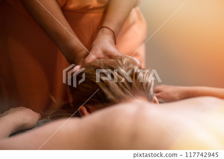 Head massage. Masseuse, client and scalp care, headache treatment and physiotherapy for healing Head massage. Masseuse, client and scalp care, headache treatment and physiotherapy for healing 117742945