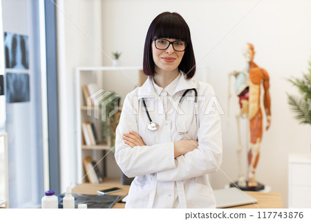 Confident female doctor with stethoscope in modern office Confident female doctor with stethoscope in modern office 117743876