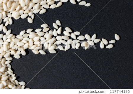 Macro kernels of white roasted sesame seeds. Macro kernels of white roasted sesame seeds. 117744125