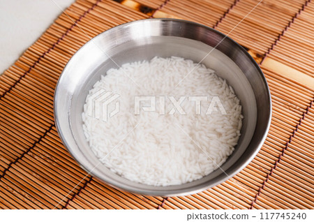 Thai glutinous rice that has been washed and soaked in water Thai glutinous rice that has been washed and soaked in water 117745240