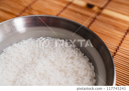 Thai glutinous rice that has been washed and soaked in water Thai glutinous rice that has been washed and soaked in water 117745241