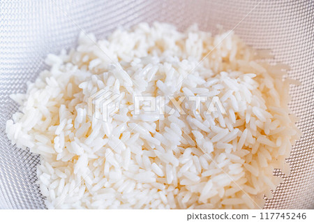 Thai glutinous rice drained in a colander Thai glutinous rice drained in a colander 117745246