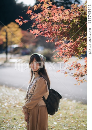 Casual dress elegance, Asian woman explores Kyoto's fall beauty, capturing cheerful smiles amid vibrant foliage and the scenic allure of Japanese tradition during a holiday. Casual dress elegance, Asian woman explores Kyoto's fall beauty, capturing cheerful smiles amid vibrant foliage and the scenic allure of Japanese tradition during a holiday. 117745441
