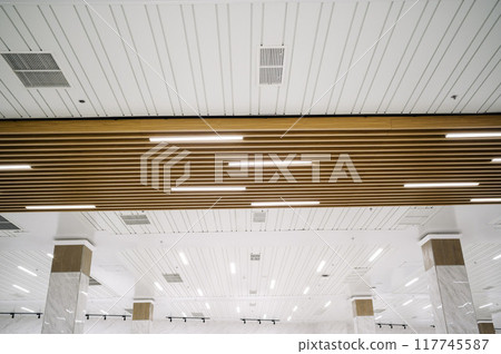 Ceiling mounted cassette type air conditioner and modern lamp light on a white ceiling. duct air conditioner for office or home 117745587